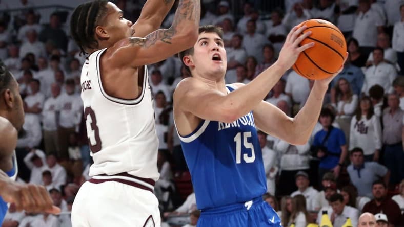 Feb 27, 2024; Starkville, Mississippi, USA; Kentucky Wildcats guard Reed Sheppard (15) drives to the basket as Mississippi State Bulldogs guard Shakeel Moore (3) defends during the second half at Humphrey Coliseum. Mandatory Credit: Petre Thomas-USA TODAY Sports