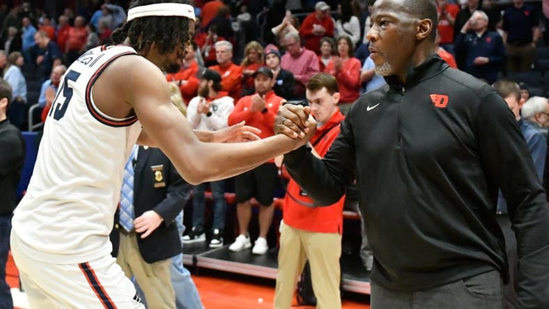 Feb 27, 2024; Dayton, Ohio, USA;  Dayton Flyers forward DaRon Holmes II (15) and head coach Anthony Grant shakes hands after the game against Davidson Wildcats at University of Dayton Arena. Mandatory Credit: Matt Lunsford-USA TODAY Sports