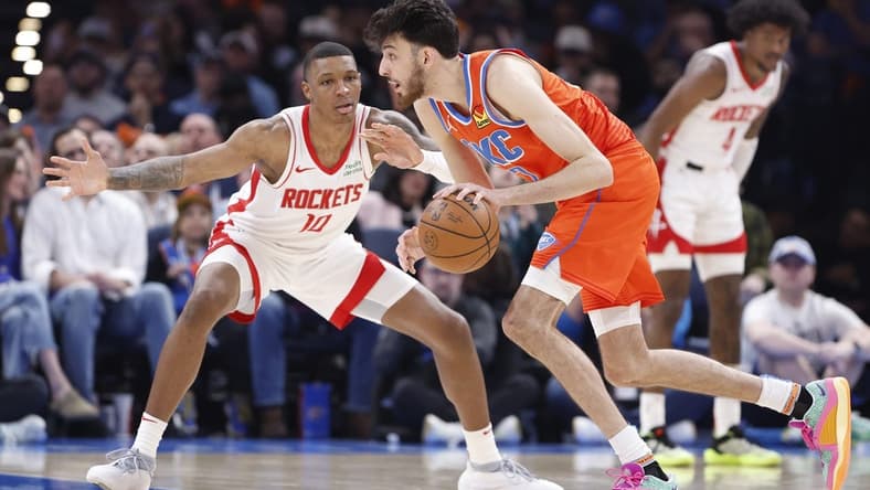 Feb 27, 2024; Oklahoma City, Oklahoma, USA; Oklahoma City Thunder forward Chet Holmgren (7) moves the ball as Houston Rockets forward Jabari Smith Jr. (10) defends during the second half at Paycom Center. Mandatory Credit: Alonzo Adams-USA TODAY Sports