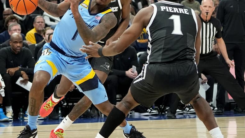Feb 28, 2024; Milwaukee, Wisconsin, USA; Marquette guard Kam Jones (1) makes a move on Providence guard Jayden Pierre (1) during the first half of their game at Fiserv Forum. Mandatory Credit: Mark Hoffman/Milwaukee Journal Sentinel-USA TODAY Sports