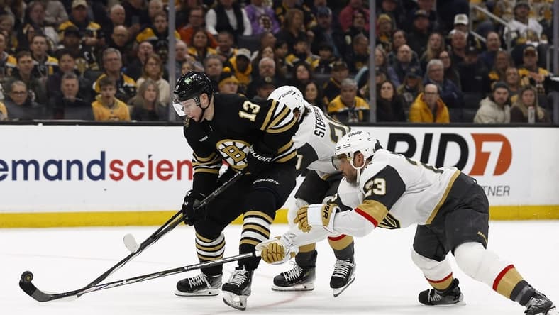 Feb 29, 2024; Boston, Massachusetts, USA; Vegas Golden Knights defenseman Alec Martinez (23) knocks the puck off the stick of Boston Bruins center Charlie Coyle (13) during the first period at TD Garden. Mandatory Credit: Winslow Townson-USA TODAY Sports