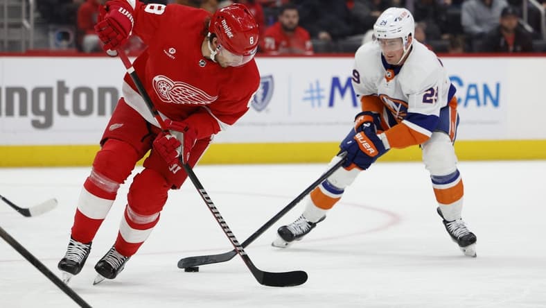 Feb 29, 2024; Detroit, Michigan, USA; New York Islanders center Brock Nelson (29) skates with the puck defended by Detroit Red Wings defenseman Ben Chiarot (8) in the first period at Little Caesars Arena. Mandatory Credit: Rick Osentoski-USA TODAY Sports