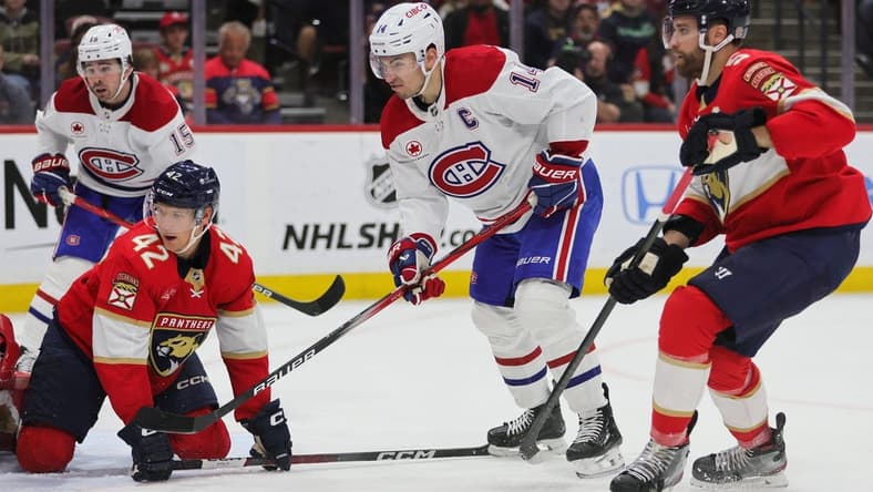 Feb 29, 2024; Sunrise, Florida, USA; Montreal Canadiens center Nick Suzuki (14) watches his shot against the Florida Panthers during the first period at Amerant Bank Arena. Mandatory Credit: Sam Navarro-USA TODAY Sports