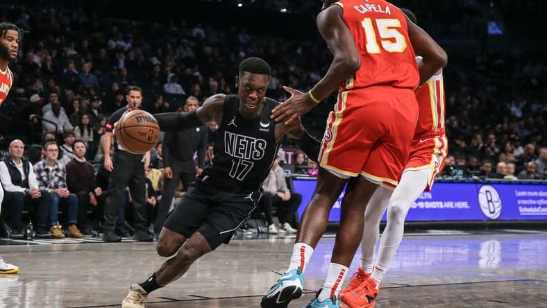 Feb 29, 2024; Brooklyn, New York, USA; Brooklyn Nets guard Dennis Schroder (17) moves the ball against Atlanta Hawks center Clint Capela (15) in the first quarter at Barclays Center. Mandatory Credit: Wendell Cruz-USA TODAY Sports