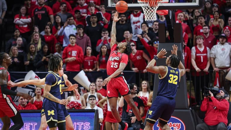 Feb 29, 2024; Piscataway, New Jersey, USA; Rutgers Scarlet Knights guard Jeremiah Williams (25) scores a basket in front of Michigan Wolverines forward Tarris Reed Jr. (32) during the first half at Jersey Mike's Arena. Mandatory Credit: Vincent Carchietta-USA TODAY Sports