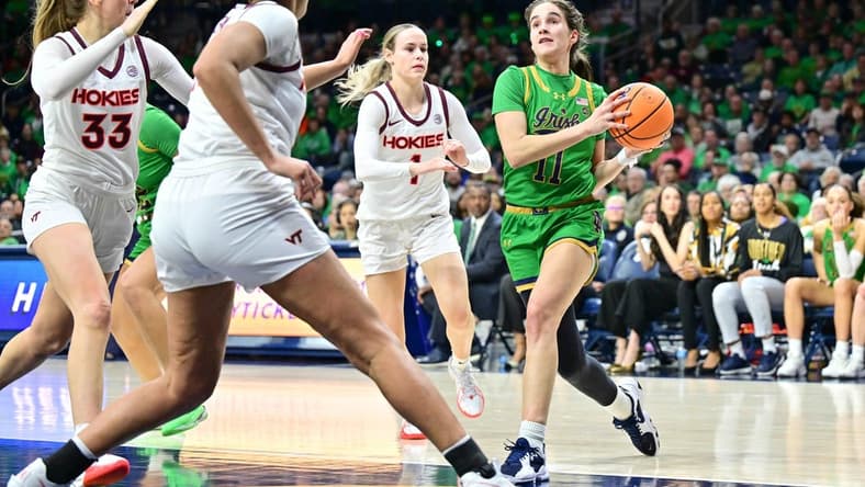 Feb 29, 2024; South Bend, Indiana, USA; Notre Dame Fighting Irish guard Sonia Citron (11) drives to the basket as Virginia Tech Hokies Carleigh Wenzel (1) defends in the second half at the Purcell Pavilion. Mandatory Credit: Matt Cashore-USA TODAY Sports