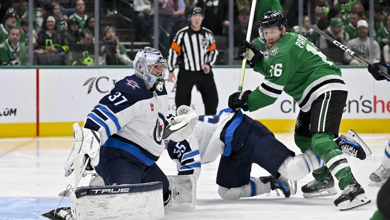 Feb 29, 2024; Dallas, Texas, USA; Dallas Stars center Joe Pavelski (16) checks Winnipeg Jets center Mark Scheifele (55) as goaltender Connor Hellebuyck (37) looks for the puck in the Jets zone during the second period at the American Airlines Center. Mandatory Credit: Jerome Miron-USA TODAY Sports