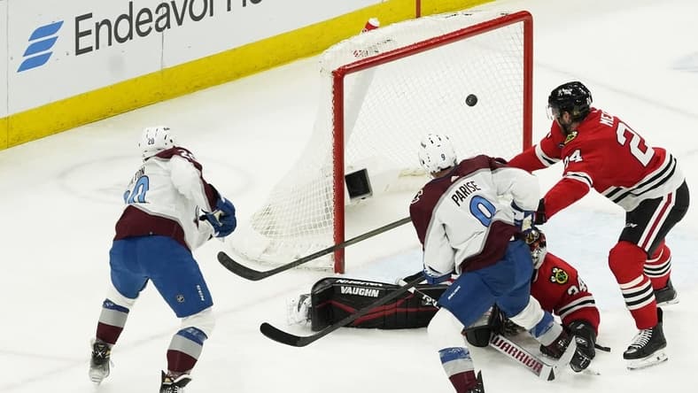 Feb 29, 2024; Chicago, Illinois, USA; Colorado Avalanche center Ross Colton (20) scores a goal on Chicago Blackhawks goaltender Petr Mrazek (34) during the second period at United Center. Mandatory Credit: David Banks-USA TODAY Sports