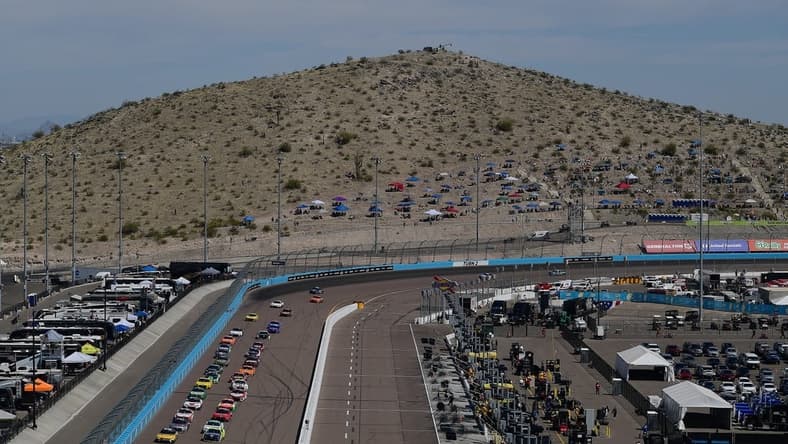 Mar 13, 2022; Avondale, Arizona, USA; General view as NASCAR Cup Series driver Kyle Busch (18) and driver Ryan Blaney (12) lead the field for the restart of the Ruoff Mortgage 500 at Phoenix Raceway. Mandatory Credit: Gary A. Vasquez-USA TODAY Sports