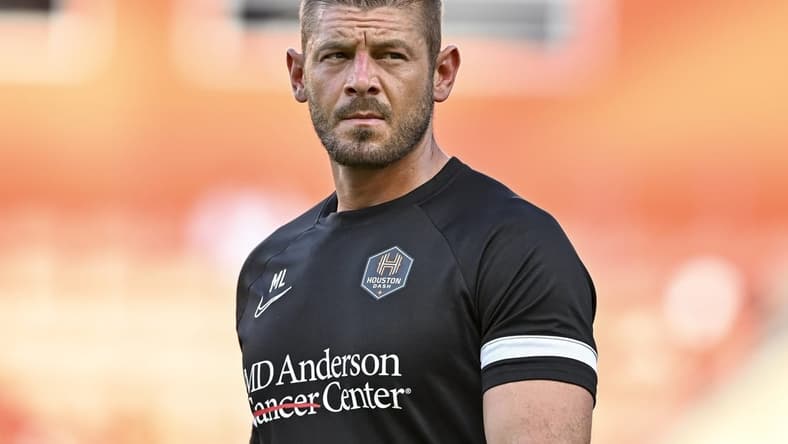Jun 12, 2022; Houston, Texas, USA; Houston Dash goalkeeper coach Matt Lampson enters the pitch prior to the start of the second half against the Portland Thorns FC in a NWSL match at PNC Stadium. Mandatory Credit: Maria Lysaker-USA TODAY Sports