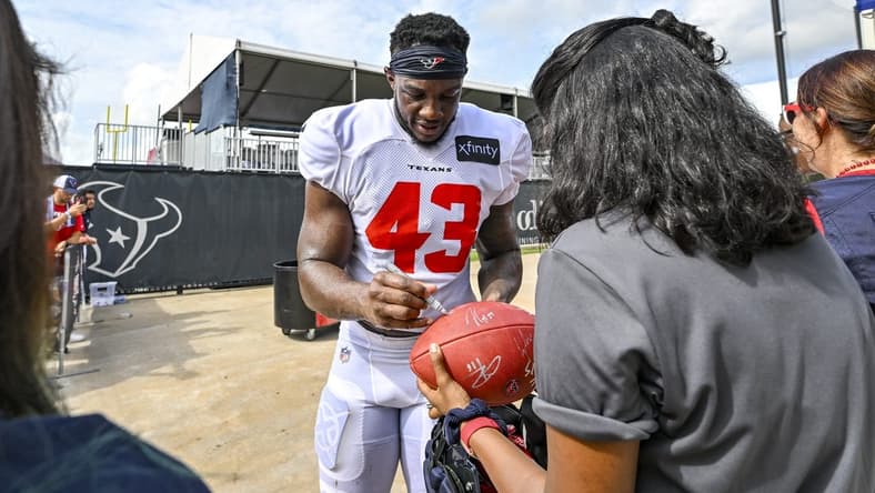 Aug 5, 2022; Houston, Texas, US; Houston Texans linebacker Neville Hewitt (43) signs autographs after training camp at the Texans practice facility.  Mandatory Credit: Maria Lysaker-USA TODAY Sports