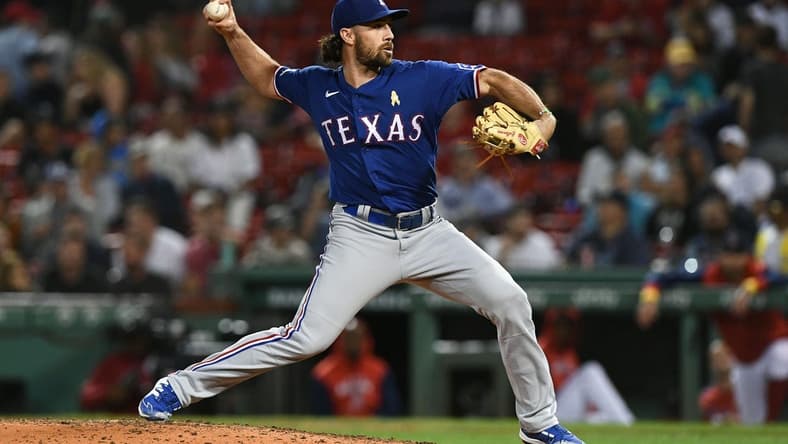 Sep 2, 2022; Boston, Massachusetts, USA; Texas Rangers third baseman Charlie Culberson (11) pitches against the Boston Red Sox during the eighth inning at Fenway Park. Mandatory Credit: Brian Fluharty-USA TODAY Sports