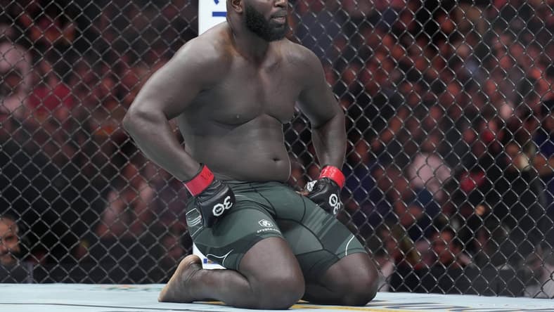 May 13, 2023; Charlotte, North Carolina, USA; Jairzinho Rozenstruik (red gloves) reacts after a loss to Jailton Almeida (blue gloves) in a heavyweight bout during UFC Fight Night at Spectrum Center. Mandatory Credit: Jim Dedmon-USA TODAY Sports