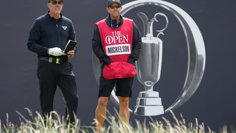 July 21, 2023; Hoylake, ENGLAND, GBR; Phil Mickelson (LIV player) and his caddie Tim Mickelson on the first hole during the second round of The Open Championship golf tournament at Royal Liverpool. Mandatory Credit: Kyle Terada-USA TODAY Sports