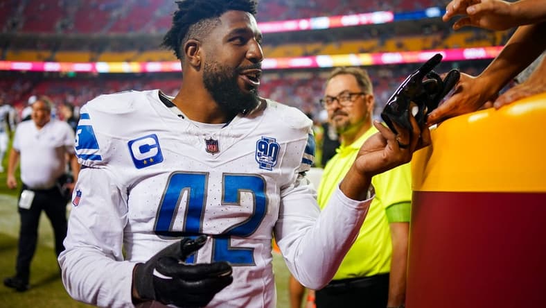 Sep 7, 2023; Kansas City, Missouri, USA; Detroit Lions linebacker Jalen Reeves-Maybin (42) gives a glove to a fan after defeating the Kansas City Chiefs at GEHA Field at Arrowhead Stadium. Mandatory Credit: Jay Biggerstaff-USA TODAY Sports