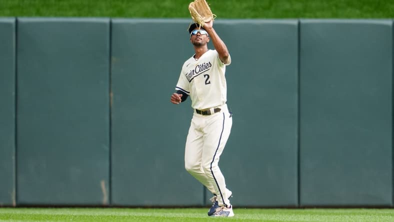 Sep 24, 2023; Minneapolis, Minnesota, USA; Minnesota Twins center fielder Michael A. Taylor (2) catches a ball to retire Los Angeles Angels catcher Logan O'Hoppe (14) in the second inning at Target Field. Mandatory Credit: Matt Blewett-USA TODAY Sports