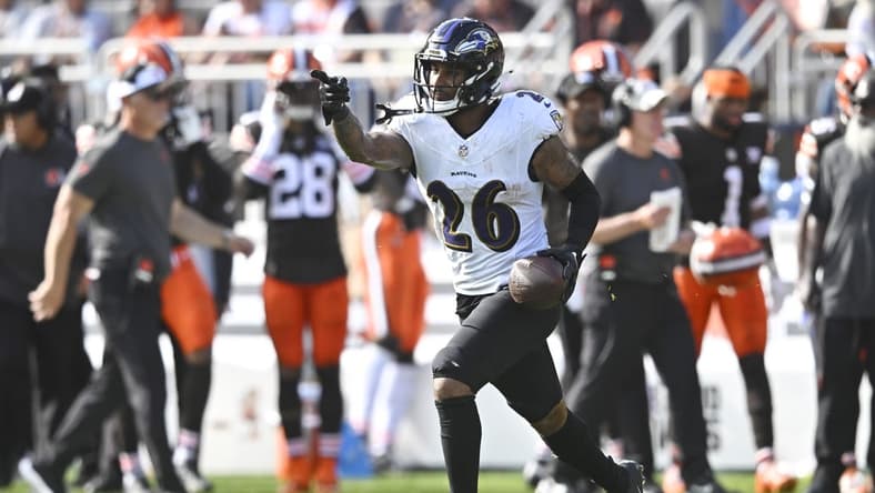 Baltimore Ravens safety Geno Stone (26) celebrates after intercepting a pass in the first quarter against the Cleveland Browns at Cleveland Browns Stadium. Mandatory Credit: David Richard-USA TODAY Sports
