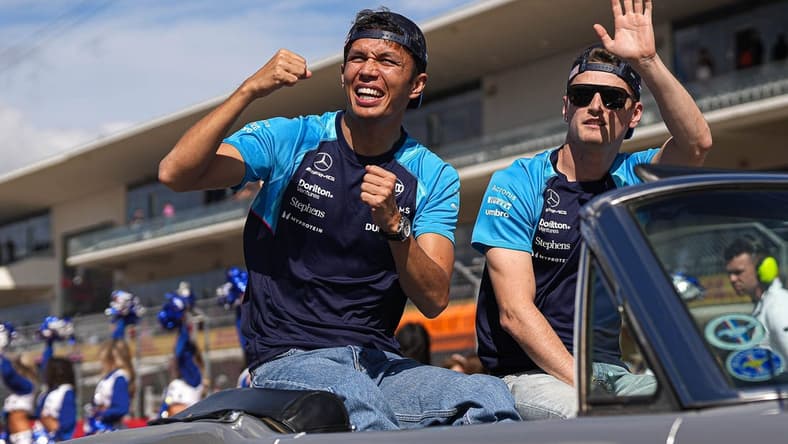 Williams Racing drivers Alex Albon, left, and Logan Sargeant, right wave to the crowd during the drivers parade ahead of the Formula 1 Lenovo United States Grand Prix at Circuit of Americas on Sunday Oct. 22, 2023.