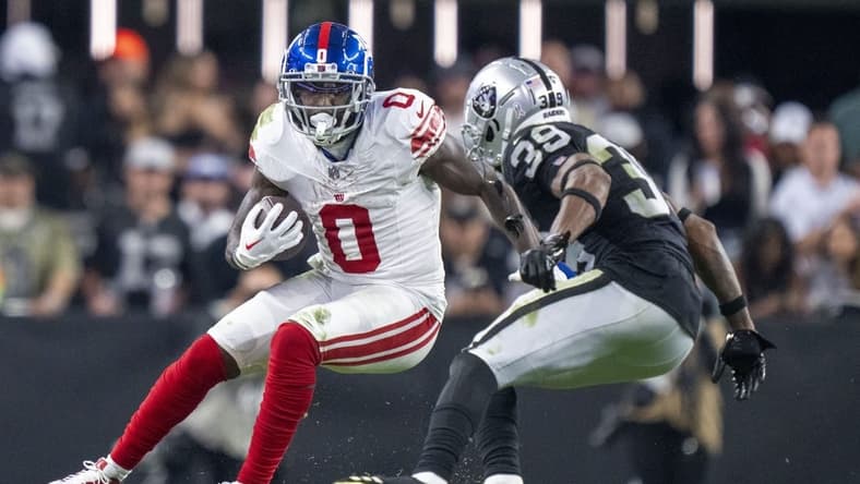 November 5, 2023; Paradise, Nevada, USA; New York Giants wide receiver Parris Campbell (0) runs the football against Las Vegas Raiders cornerback Nate Hobbs (39) during the fourth quarter at Allegiant Stadium. Mandatory Credit: Kyle Terada-USA TODAY Sports