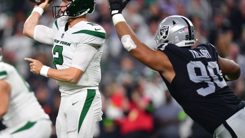Nov 12, 2023; Paradise, Nevada, USA; New York Jets quarterback Zach Wilson (2) throws under pressure from Las Vegas Raiders defensive tackle Jerry Tillery (90) during the second half at Allegiant Stadium. Mandatory Credit: Gary A. Vasquez-USA TODAY Sports