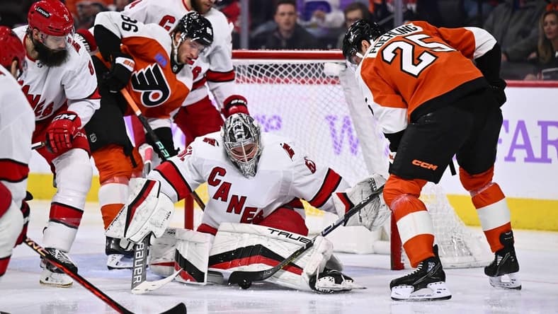 Nov 28, 2023; Philadelphia, Pennsylvania, USA; Carolina Hurricanes goalie Pyotr Kochetkov (52) makes a save against Philadelphia Flyers center Ryan Poehling (25) in the second period at Wells Fargo Center. Mandatory Credit: Kyle Ross-USA TODAY Sports