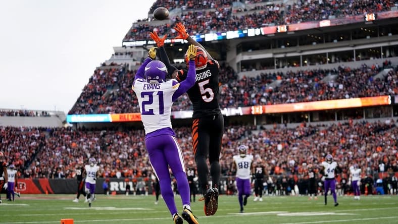 Cincinnati Bengals wide receiver Tee Higgins (5) catches a touchdown pass as Minnesota Vikings cornerback Akayleb Evans (21) defends in the fourth quarter of a Week 15 NFL football game between the Minnesota Vikings and the Cincinnati Bengals, Saturday, Dec. 16, 2023, at Paycor Stadium in Cincinnati. The Cincinnati Bengals won 27-24 in overtime.