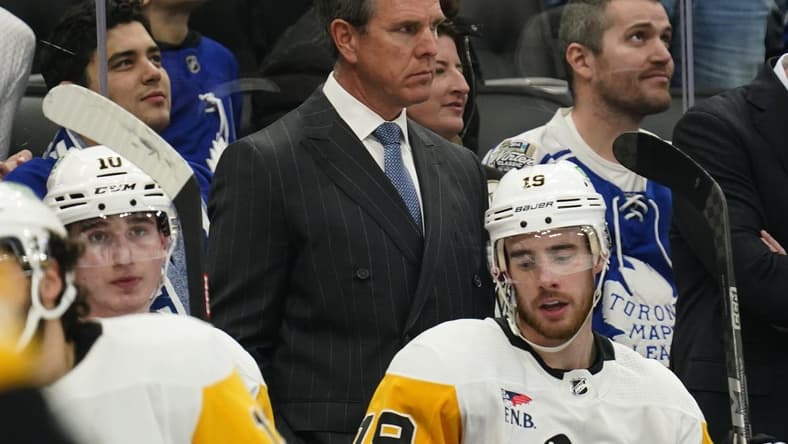 Dec 16, 2023; Toronto, Ontario, CAN; Pittsburgh Penguins head coach Mike Sullivan (middle) looks on from the bench during the second period against the Toronto Maple Leafs at Scotiabank Arena. Mandatory Credit: John E. Sokolowski-USA TODAY Sports