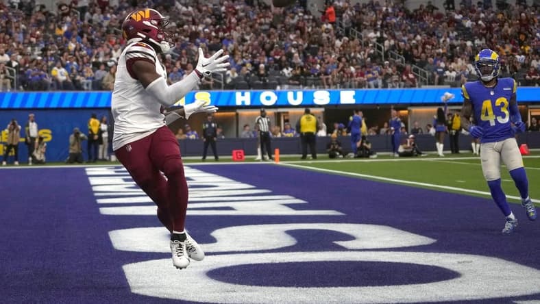 Dec 17, 2023; Inglewood, California, USA; Washington Commanders wide receiver Curtis Samuel (4) catches a touchdown pass in the second half against the Los Angeles Rams at SoFi Stadium. Mandatory Credit: Kirby Lee-USA TODAY Sports