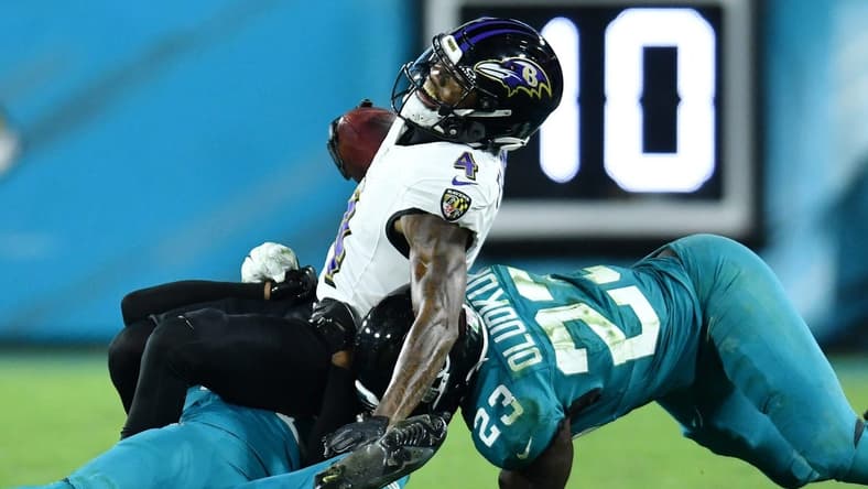 Jacksonville Jaguars cornerback Montaric Brown (30) and linebacker Foyesade Oluokun (23) make the tackle on Baltimore Ravens wide receiver Zay Flowers (4) during third quarter action. The Jacksonville Jaguars hosted the Baltimore Ravens at EverBank Stadium in Jacksonville, Florida Sunday Night, December 17, 2023. The Jaguars trailed 10 to 0 at the half and lost 23 to 7. [Bob Self/Florida Times-Union]