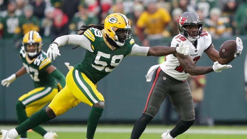 Tampa Bay Buccaneers wide receiver David Moore (19) breaks away from Green Bay Packers linebacker De'Vondre Campbell (59) for a 52-yard touchdown reception during their football game Sunday, December 17, 2023, at Lambeau Field in Green Bay, Wis.