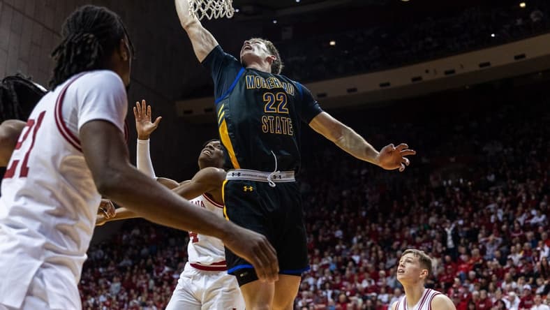 Dec 19, 2023; Bloomington, Indiana, USA; Morehead State Eagles guard Riley Minix (22) shoots the ball while Indiana Hoosiers forward Anthony Walker (4) defends in the second half at Simon Skjodt Assembly Hall. Mandatory Credit: Trevor Ruszkowski-USA TODAY Sports