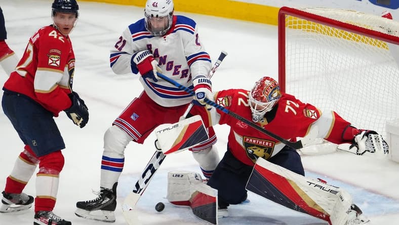 Dec 29, 2023; Sunrise, Florida, USA; Florida Panthers goaltender Sergei Bobrovsky (72) stops a shot behind New York Rangers center Barclay Goodrow (21) during the third period at Amerant Bank Arena. Mandatory Credit: Jasen Vinlove-USA TODAY Sports