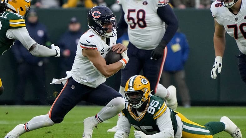Chicago Bears quarterback Justin Fields (1) runs for a first down during the first quarter of their game against the Green Bay Packers Sunday, January 7, 2024 at Lambeau Field in Green Bay, Wisconsin.Mark Hoffman/Milwaukee Journal Sentinel