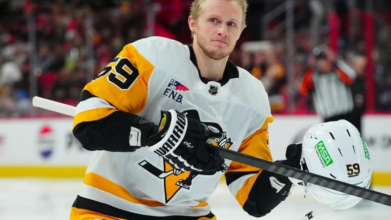 Jan 13, 2024; Raleigh, North Carolina, USA;  Pittsburgh Penguins left wing Jake Guentzel (59) looks on at the start of the game against the Carolina Hurricanes at PNC Arena. Mandatory Credit: James Guillory-USA TODAY Sports