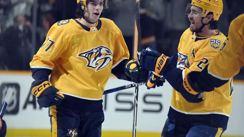 Jan 13, 2024; Nashville, Tennessee, USA; Nashville Predators right wing Luke Evangelista (77) celebrates with /defenseman Ryan McDonagh (27) after scoring during the third period against the New York Islanders at Bridgestone Arena. Mandatory Credit: Christopher Hanewinckel-USA TODAY Sports