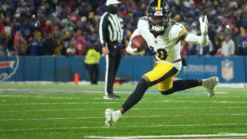 Jan 15, 2024; Orchard Park, New York, USA; Pittsburgh Steelers wide receiver Diontae Johnson (18) runs the ball in the second half against the Buffalo Bills in a 2024 AFC wild card game at Highmark Stadium. Mandatory Credit: Kirby Lee-USA TODAY Sports
