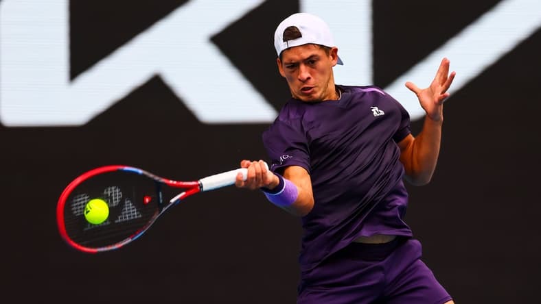 Jan 19, 2024; Melbourne, Victoria, Australia; Sebastian Baez of Argentina plays a shot against Jannik Sinner (not pictured) of Italy in Round 3 of the Men's Singles on Day 6 of the Australian Open tennis at Margaret Court Arena. Mandatory Credit: Mike Frey-USA TODAY Sports
