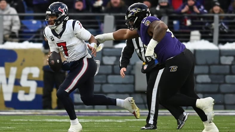 Jan 20, 2024; Baltimore, MD, USA; Houston Texans quarterback C.J. Stroud (7) runs the ball against Baltimore Ravens defensive tackle Justin Madubuike (92) during the first quarter of a 2024 AFC divisional round game at M&T Bank Stadium. Mandatory Credit: Tommy Gilligan-USA TODAY Sports