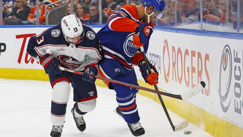 Jan 23, 2024; Edmonton, Alberta, CAN; Columbus Blue Jackets forward Johnny Gaudreau (13) and Edmonton Oilers defensemen Darnell Nurse (25) battle during the second period at Rogers Place. Mandatory Credit: Perry Nelson-USA TODAY Sports
