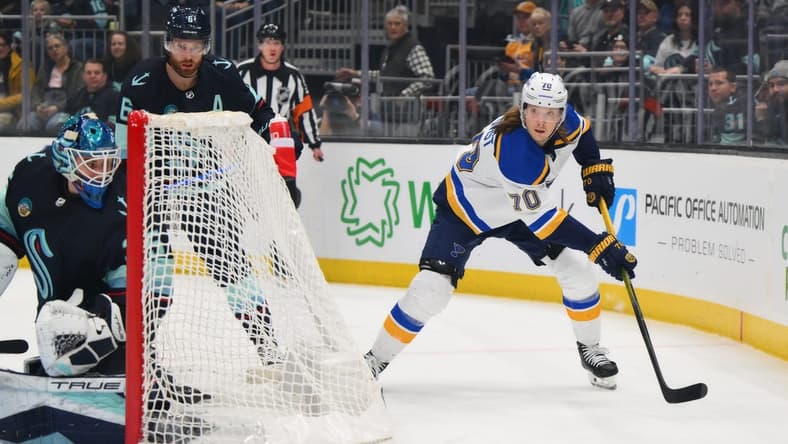 Jan 26, 2024; Seattle, Washington, USA; St. Louis Blues center Oskar Sundqvist (70) plays the puck behind the goal against the Seattle Kraken during the first period at Climate Pledge Arena. Mandatory Credit: Steven Bisig-USA TODAY Sports