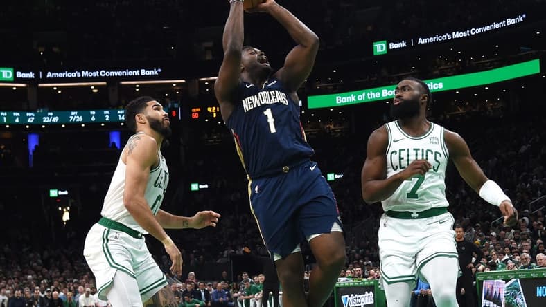 Jan 29, 2024; Boston, Massachusetts, USA;  New Orleans Pelicans forward Zion Williamson (1) shoots the ball between Boston Celtics forward Jayson Tatum (0) and guard Jaylen Brown (7) during the second half at TD Garden. Mandatory Credit: Bob DeChiara-USA TODAY Sports