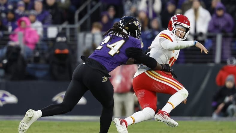 Jan 28, 2024; Baltimore, Maryland, USA; Kansas City Chiefs quarterback Patrick Mahomes (15) is knocked down after passing the ball by Baltimore Ravens linebacker Jadeveon Clowney (24) in the AFC Championship football game at M&T Bank Stadium. Mandatory Credit: Geoff Burke-USA TODAY Sports