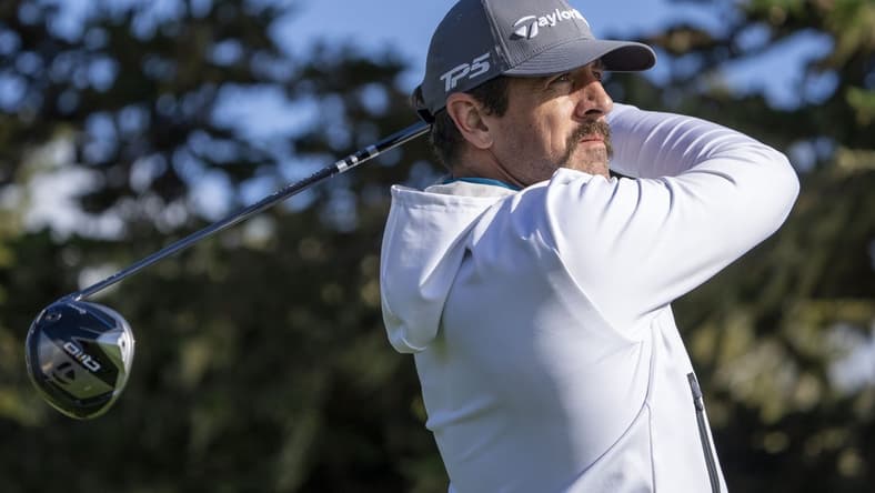 February 2, 2024; Pebble Beach, California, USA; New York Jets quarterback Aaron Rodgers hits his tee shot on the 16th hole during the second round of the AT&T Pebble Beach Pro-Am golf tournament at Pebble Beach Golf Links. Mandatory Credit: Kyle Terada-USA TODAY Sports
