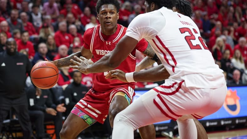 Feb 10, 2024; Piscataway, New Jersey, USA; Wisconsin Badgers guard AJ Storr (left) dribbles the ball against Rutgers Scarlet Knights center Emmanuel Ogbole (22) during the first half at Jersey Mike's Arena. Mandatory Credit: Vincent Carchietta-USA TODAY Sports