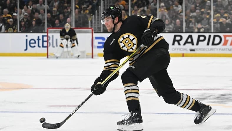 Feb 10, 2024; Boston, Massachusetts, USA; Boston Bruins defenseman Brandon Carlo (25) takes a shot against the Washington Capitals during the third period at the TD Garden. Mandatory Credit: Brian Fluharty-USA TODAY Sports