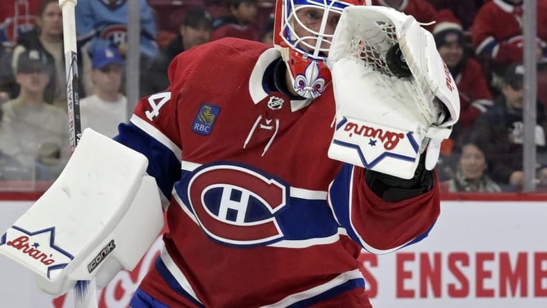 Feb 11, 2024; Montreal, Quebec, CAN; Montreal Canadiens goalie Jake Allen (34) makes a glove save during the first period of the game against the St.Louis Blues at the Bell Centre. Mandatory Credit: Eric Bolte-USA TODAY Sports