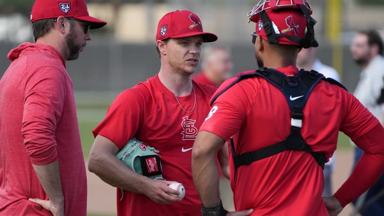 Feb 15, 2024; Jupiter, FL, USA; St. Louis Cardinals starting pitcher Sonny Gray, center, talks with catcher Ivan Herrera (48) during workouts at spring training. Mandatory Credit: Jim Rassol-USA TODAY Sports