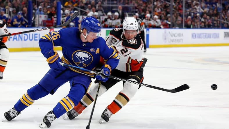 Feb 19, 2024; Buffalo, New York, USA; Buffalo Sabres defenseman Rasmus Dahlin (26) clears the puck as Anaheim Ducks center Isac Lundestrom (21) defends during the first period at KeyBank Center. Mandatory Credit: Timothy T. Ludwig-USA TODAY Sports
