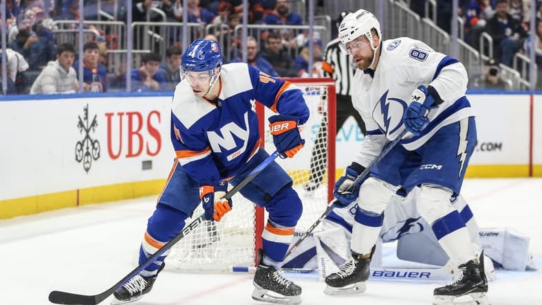 Feb 24, 2024; Elmont, New York, USA; New York Islanders center Jean-Gabriel Pageau (44) and Tampa Bay Lightning defenseman Erik Cernak (81) battle for control of the puck in the second period at UBS Arena. Mandatory Credit: Wendell Cruz-USA TODAY Sports