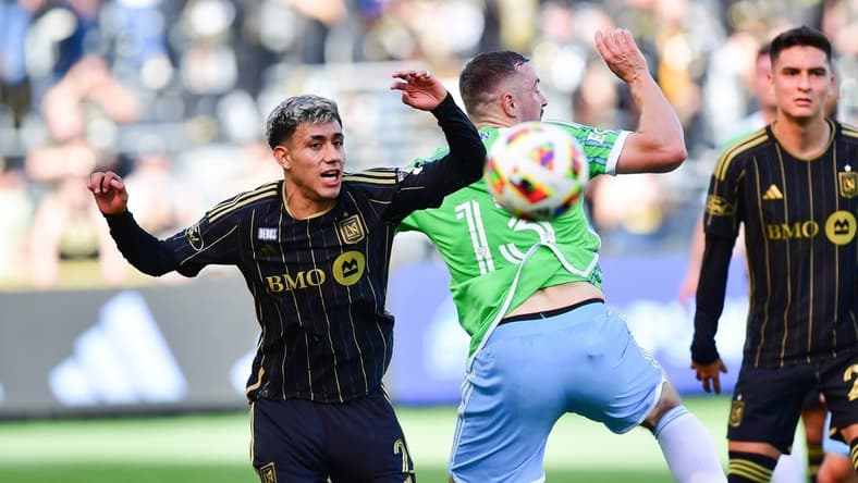 Feb 24, 2024; Los Angeles, California, USA; LAFC defender Omar Campos (2) plays for the ball against Seattle Sounders FC forward Jordan Morris (13) during the first half at BMO Stadium. Mandatory Credit: Gary A. Vasquez-USA TODAY Sports